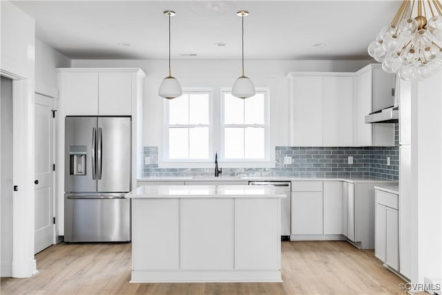 kitchen with stainless steel refrigerator with ice dispenser, dishwasher, a sink, under cabinet range hood, and light countertops