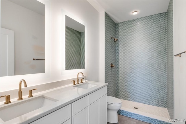 full bathroom featuring toilet, double vanity, tile patterned floors, and walk in shower