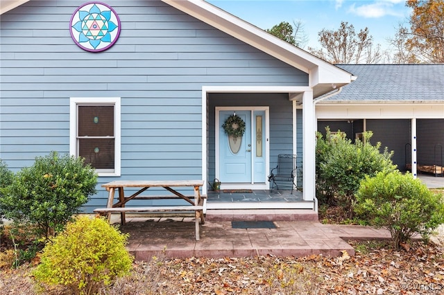 view of exterior entry with covered porch