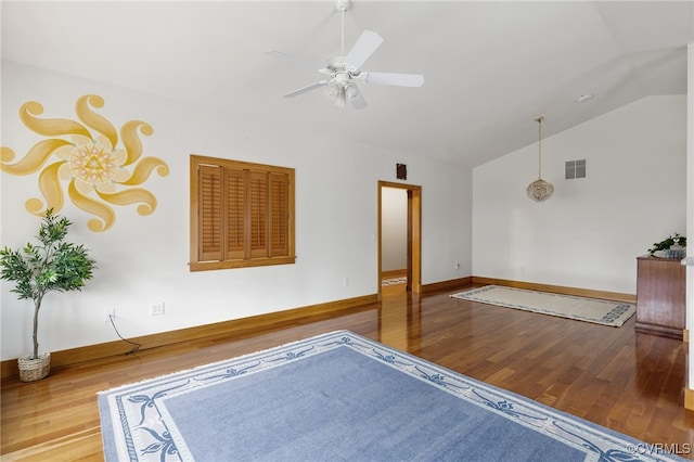 empty room with wood-type flooring, ceiling fan, and lofted ceiling