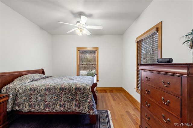 bedroom with ceiling fan and light hardwood / wood-style flooring