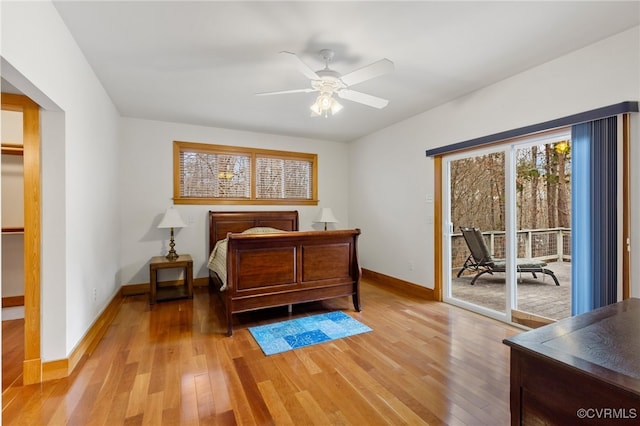 bedroom with access to exterior, light hardwood / wood-style flooring, and ceiling fan