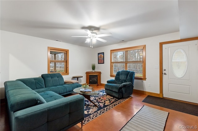 living room featuring ceiling fan and concrete floors