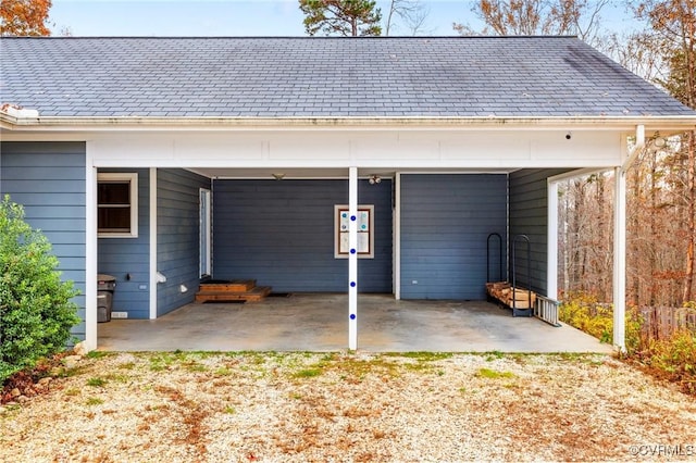 back of house featuring a carport