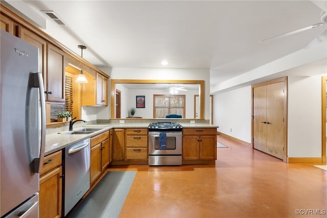 kitchen with sink, ceiling fan, appliances with stainless steel finishes, decorative light fixtures, and kitchen peninsula