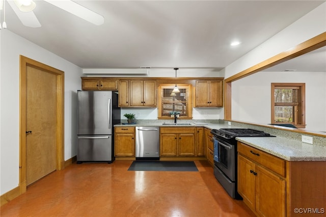 kitchen with kitchen peninsula, appliances with stainless steel finishes, light stone counters, ceiling fan, and sink