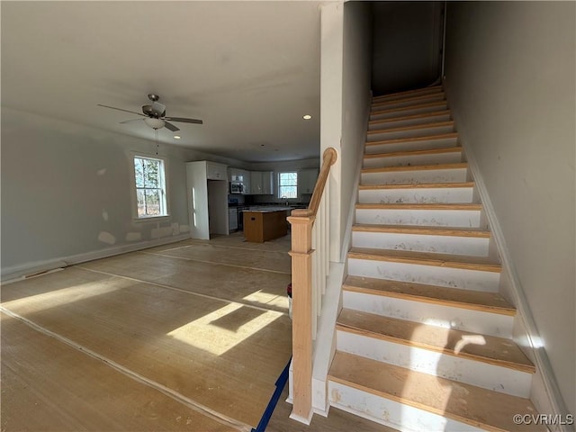 stairway featuring a ceiling fan and recessed lighting