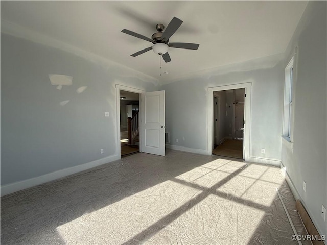 unfurnished bedroom featuring light carpet, ceiling fan, and baseboards