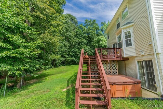 view of yard featuring a hot tub and a wooden deck