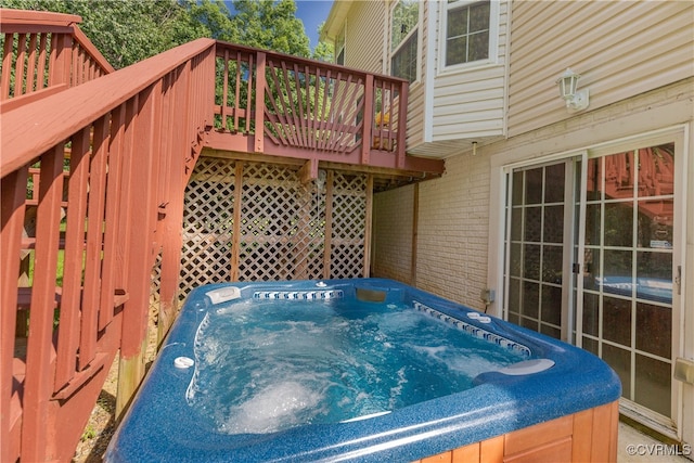 wooden deck with a hot tub