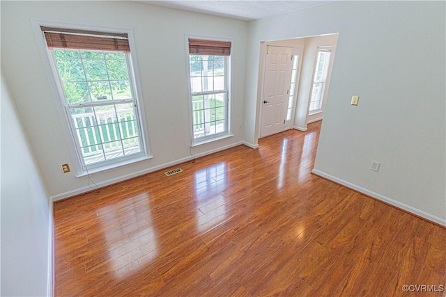 unfurnished room with light hardwood / wood-style flooring