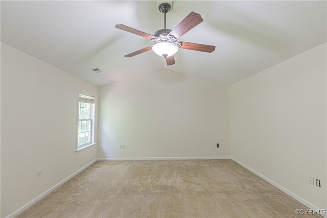 carpeted empty room with ceiling fan and vaulted ceiling