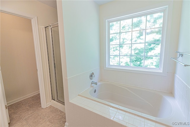 bathroom with tile patterned flooring and separate shower and tub