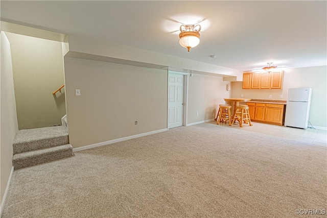 unfurnished living room featuring light carpet