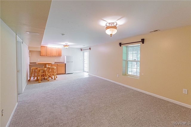 unfurnished living room with light carpet