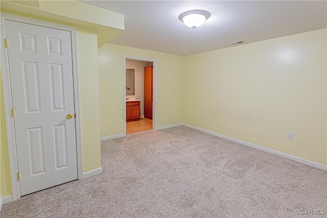 unfurnished room with light carpet