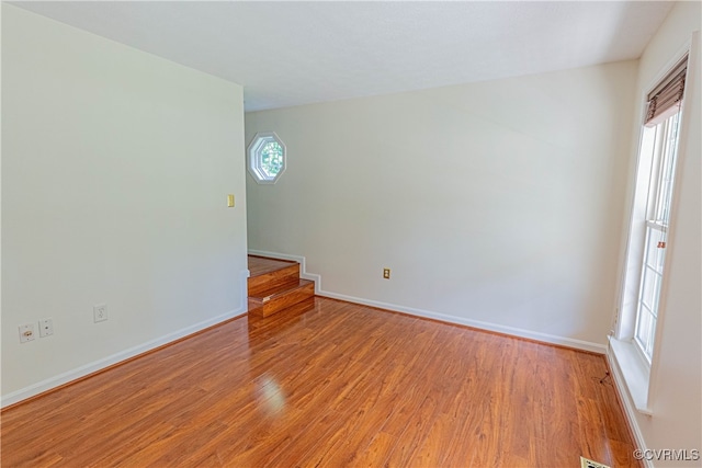 unfurnished room with light hardwood / wood-style floors