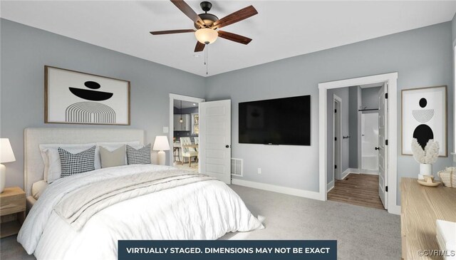 carpeted bedroom with ceiling fan, visible vents, baseboards, and connected bathroom