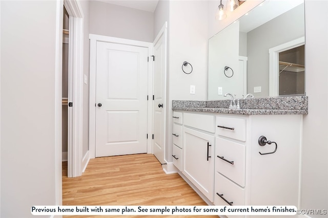 bathroom with vanity and hardwood / wood-style flooring