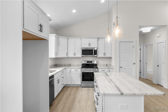 kitchen featuring a center island, white cabinets, stainless steel appliances, and light wood-style floors