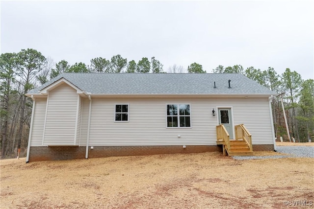 rear view of house featuring a shingled roof