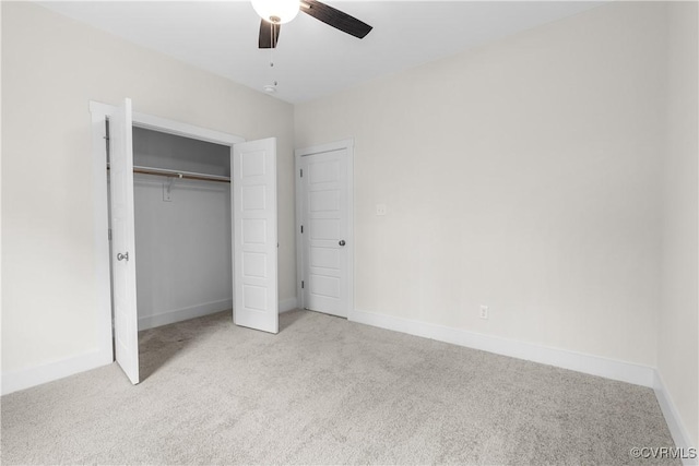 unfurnished bedroom featuring carpet flooring, baseboards, a closet, and ceiling fan