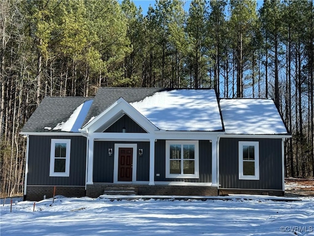 view of front of property with a porch, a shingled roof, and board and batten siding