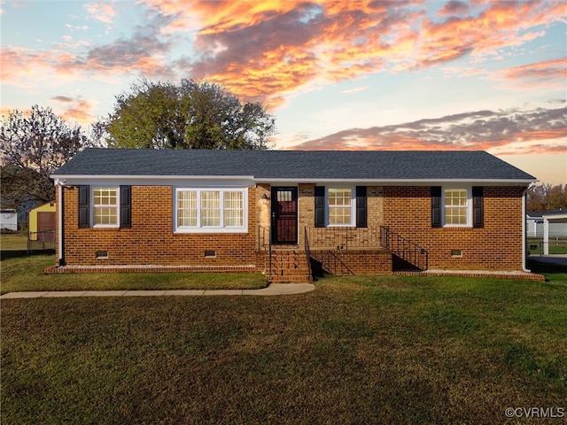 ranch-style home featuring a yard