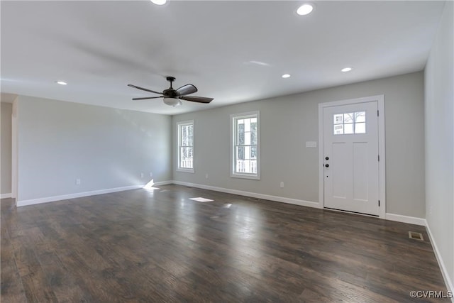 entrance foyer with ceiling fan and dark wood-type flooring