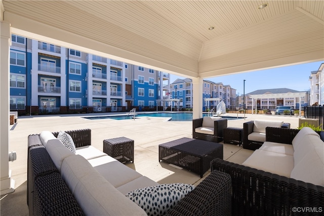 view of patio featuring outdoor lounge area and a community pool