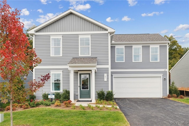 view of property featuring a front yard and a garage