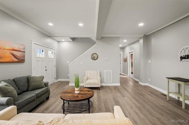 living room featuring ornamental molding and light hardwood / wood-style flooring