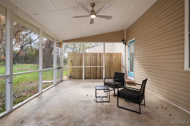 sunroom / solarium with vaulted ceiling, ceiling fan, and plenty of natural light