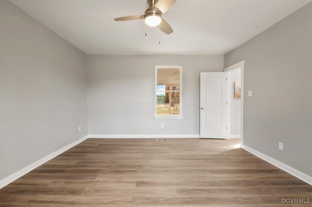 empty room featuring wood-type flooring and ceiling fan