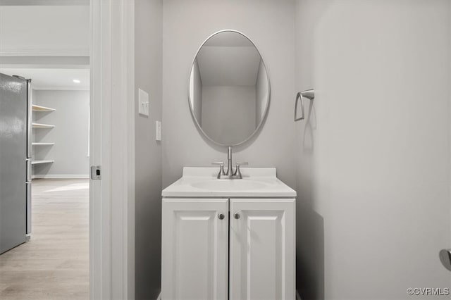 bathroom with vanity and hardwood / wood-style flooring