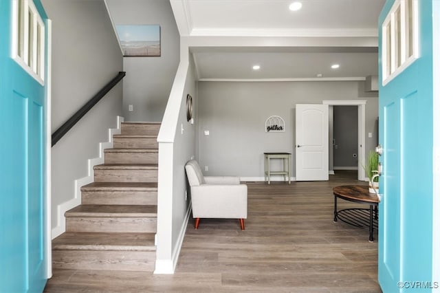 foyer with crown molding and hardwood / wood-style flooring