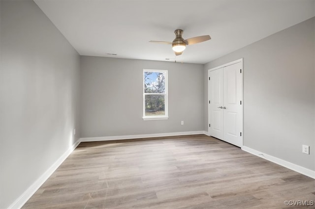 spare room featuring ceiling fan and light wood-type flooring