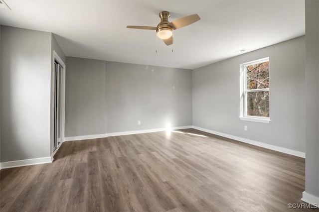 unfurnished room with hardwood / wood-style floors and ceiling fan