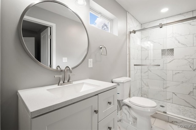 bathroom featuring vanity, toilet, and an enclosed shower