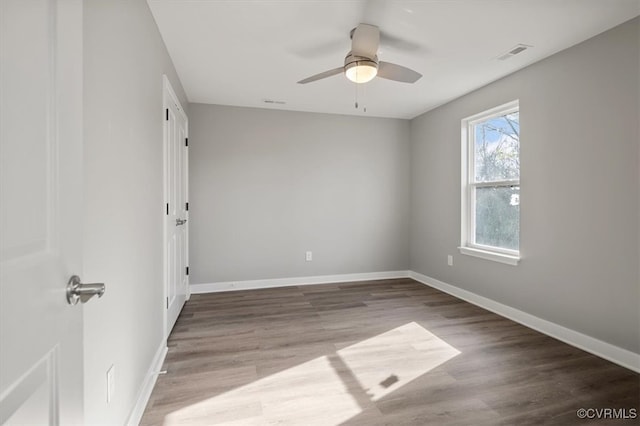 unfurnished room with hardwood / wood-style floors and ceiling fan