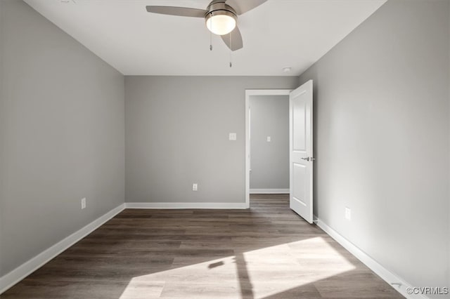 spare room featuring dark hardwood / wood-style floors and ceiling fan