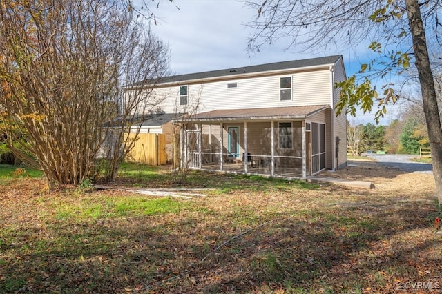 rear view of property with a sunroom