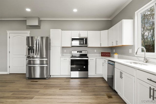 kitchen featuring appliances with stainless steel finishes, white cabinetry, and sink