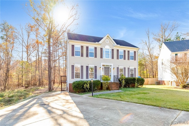 colonial home with a front lawn