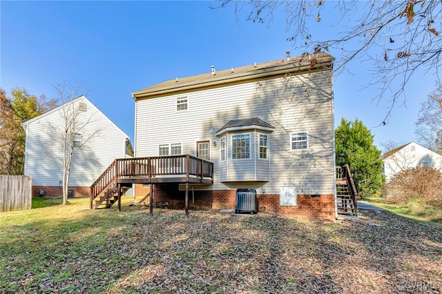 rear view of house featuring cooling unit, a deck, and a yard