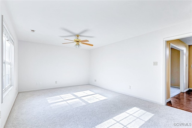 spare room with hardwood / wood-style flooring and ceiling fan