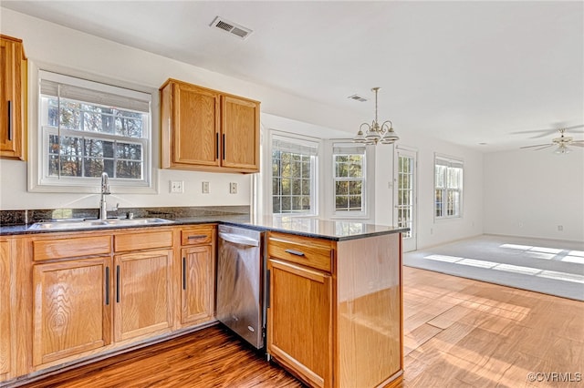 kitchen with dishwasher, hardwood / wood-style flooring, kitchen peninsula, and sink