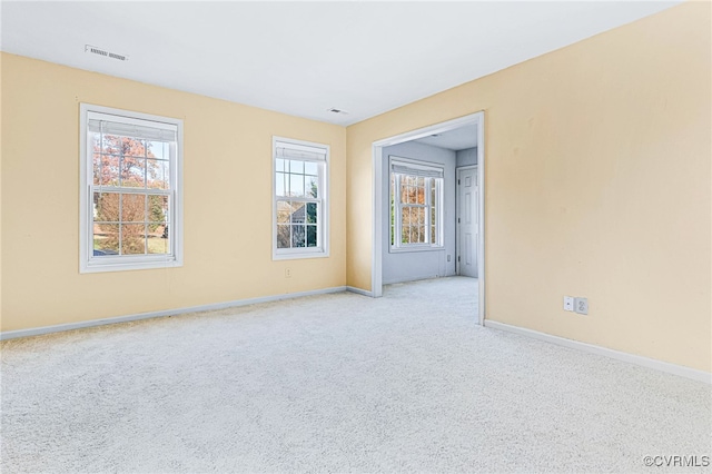 unfurnished room with light colored carpet