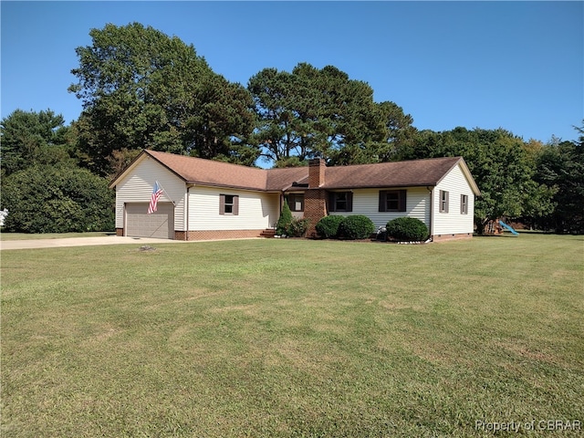 view of front of house featuring a garage and a front lawn