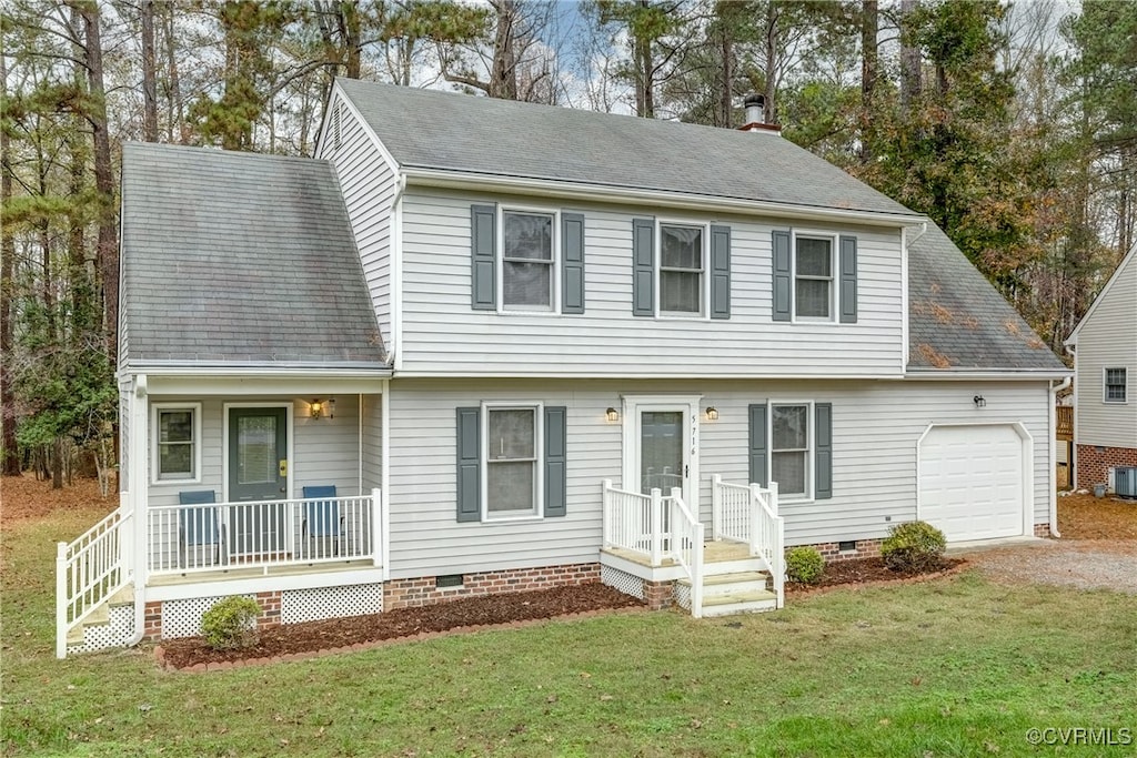 view of front of property with a front yard and a garage